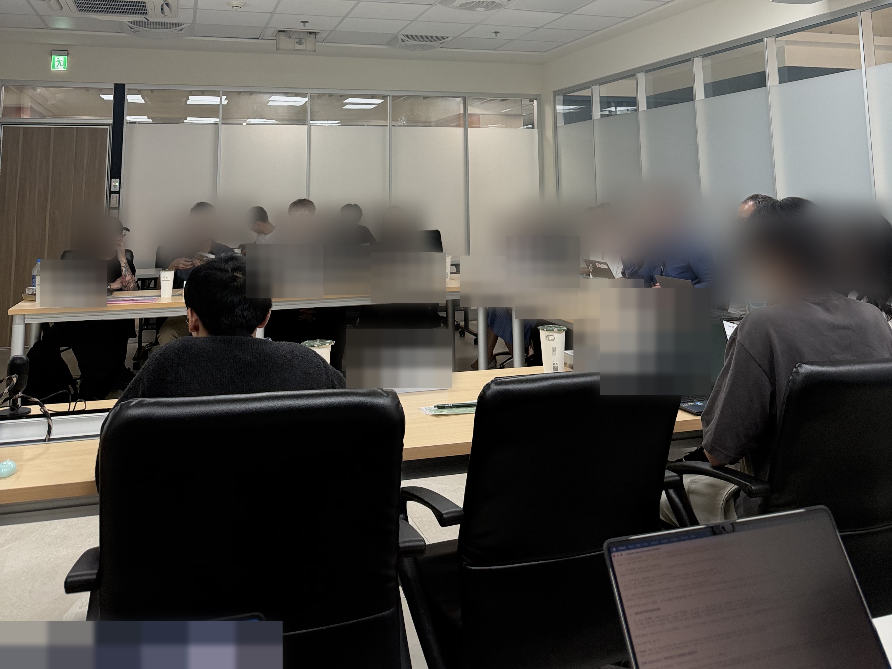 Participants seated around a conference table at a zCLOUD end-user focus group; faces and name cards are blurred for privacy.